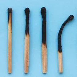 A photo of burnt matches against a blue background