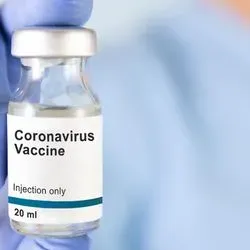 Medical professional holding a vial of COVID-19 vaccine