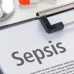 A clip board with an article about sepsis on it