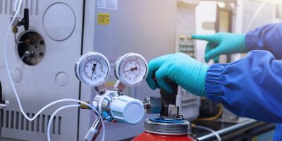 Photo of a clinical lab professional operating a HRAM GC-MS 