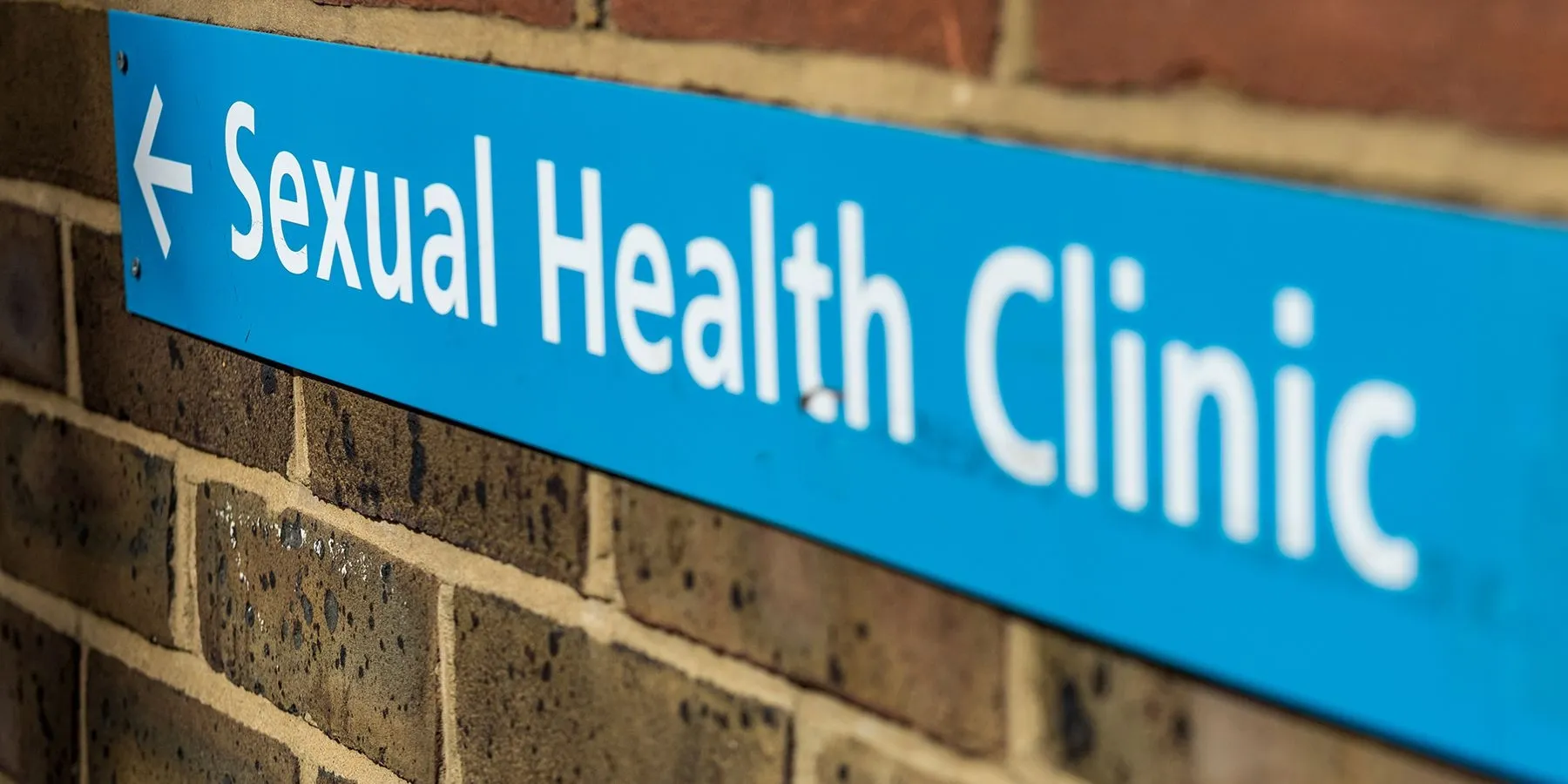 FDA Clearance and CLIA Waiver at the Point of Care for PCR Sexual Health Test Image of a sign for a sexual health clinic on a brick wall