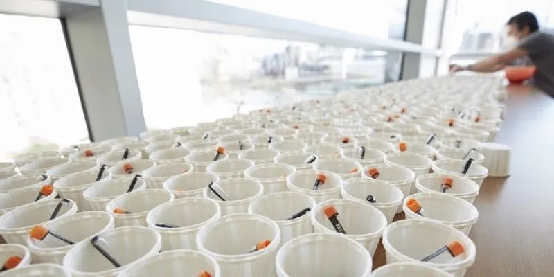 Stored in orange-capped vials for mass distribution, the DRUL buffer is part of an inexpensive saliva-based COVID test developed at Rockefeller.