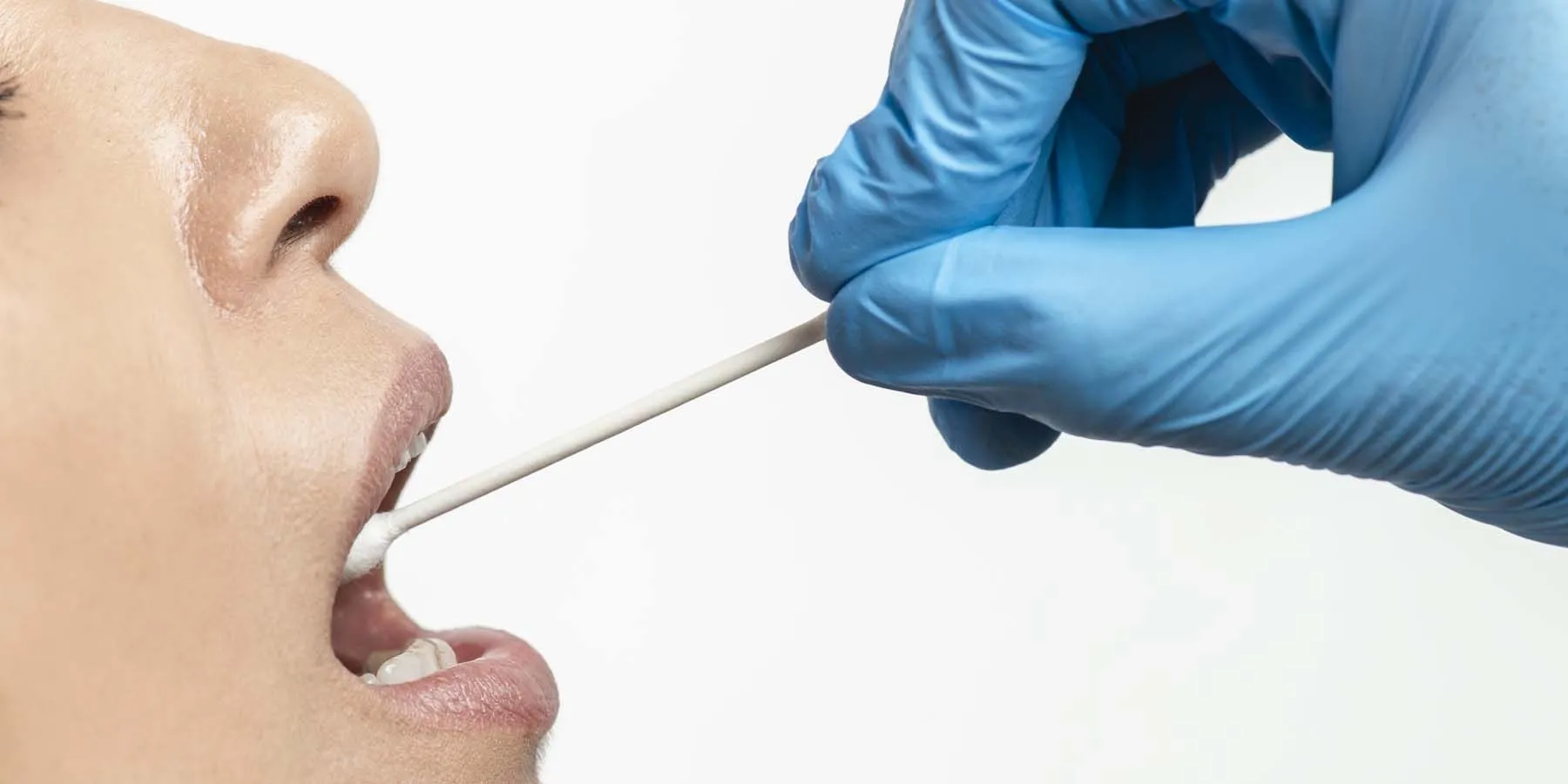 Person having a saliva sample taken