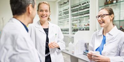 Photo of clinical lab professional leader demonstration soft skills in the lab