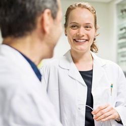 Photo of clinical lab professional leader demonstration soft skills in the lab