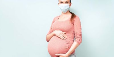 Pregnant woman wearing a face mask