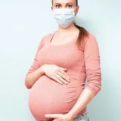 Pregnant woman wearing a face mask