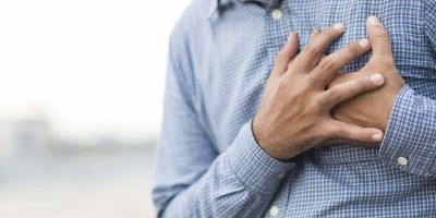 Man grasping chest in pain