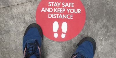 Person looking at a sign for social distancing