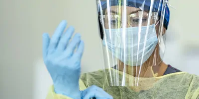 Woman health care provider wearing PPE