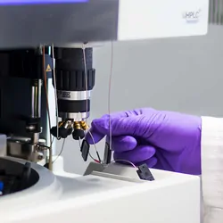 Photo of a clinical lab professional infecting a sample into a mass cytometer