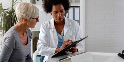 Female medical professional discussing treatment options with older female patient