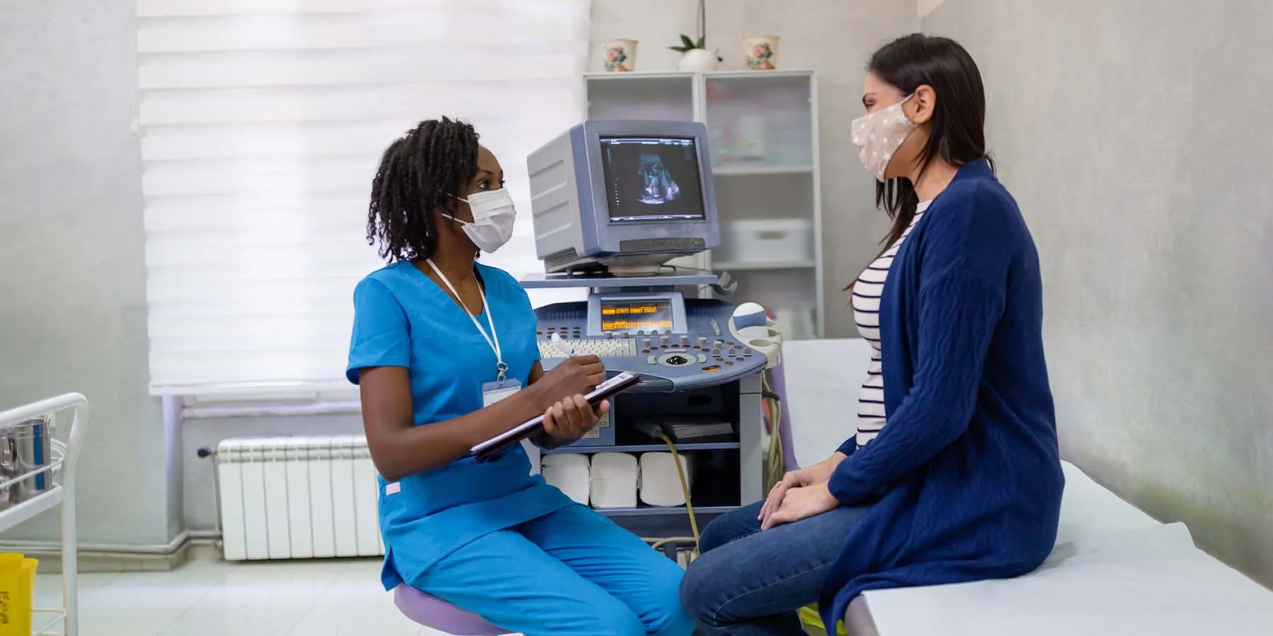 Pregnant woman speaking with a health professional