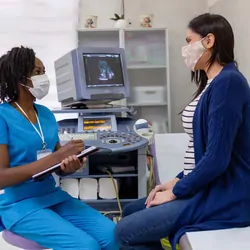 Pregnant woman speaking with a health professional