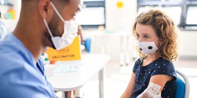 A young child getting vaccinated against COVID-19