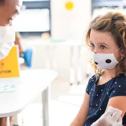 A young child getting vaccinated against COVID-19