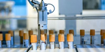 Photo of a robotics system picking up blood samples for infectious disease testing