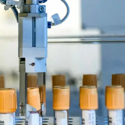 Photo of a robotics system picking up blood samples for infectious disease testing