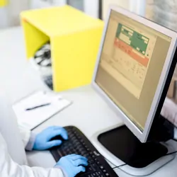 High Angle View of Young Female Doctor Using Computer in Laboratory