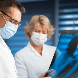 Two researchers looking at X-rays