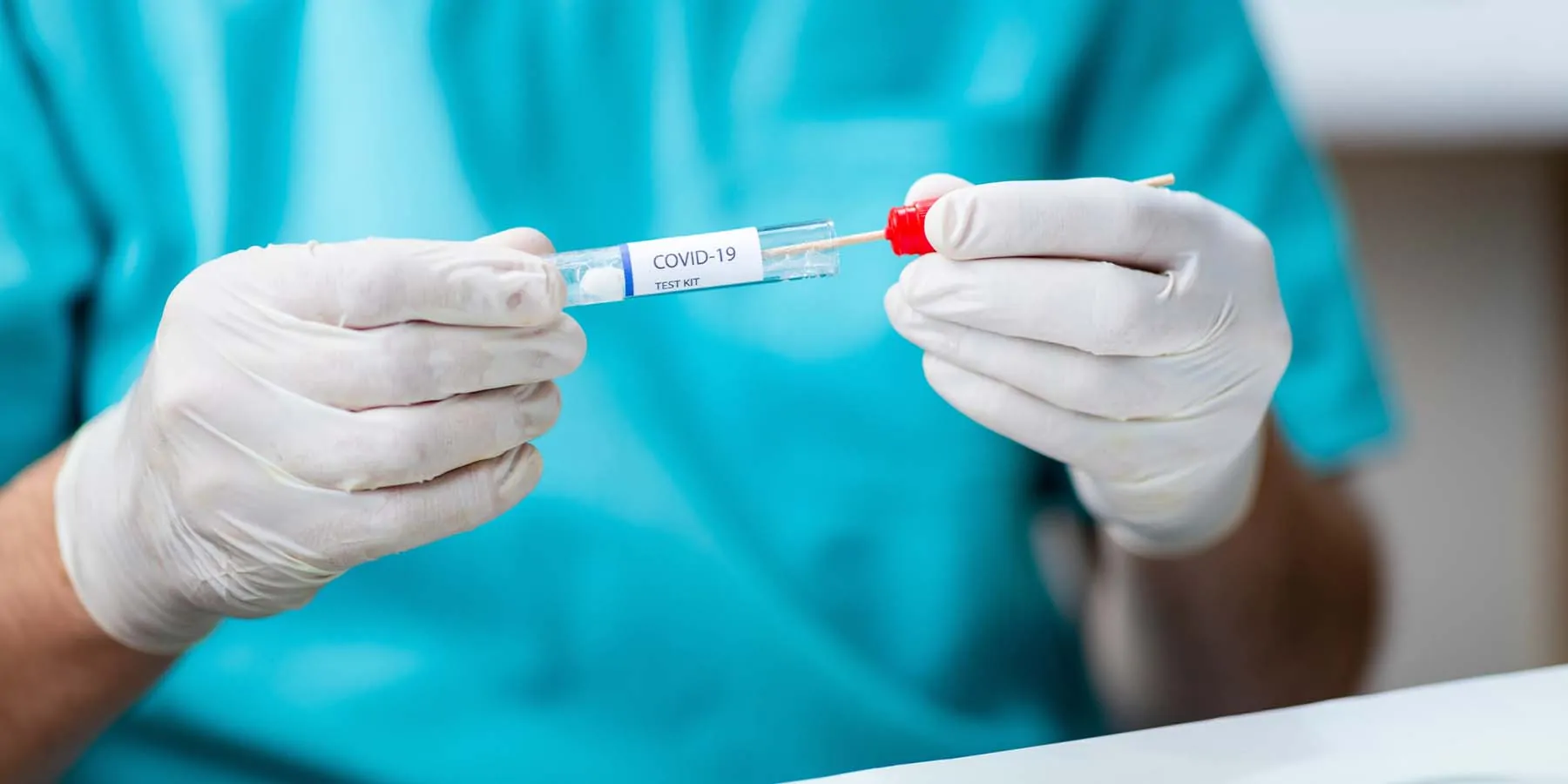 Health care professional puttng Cotton swab into test tube 