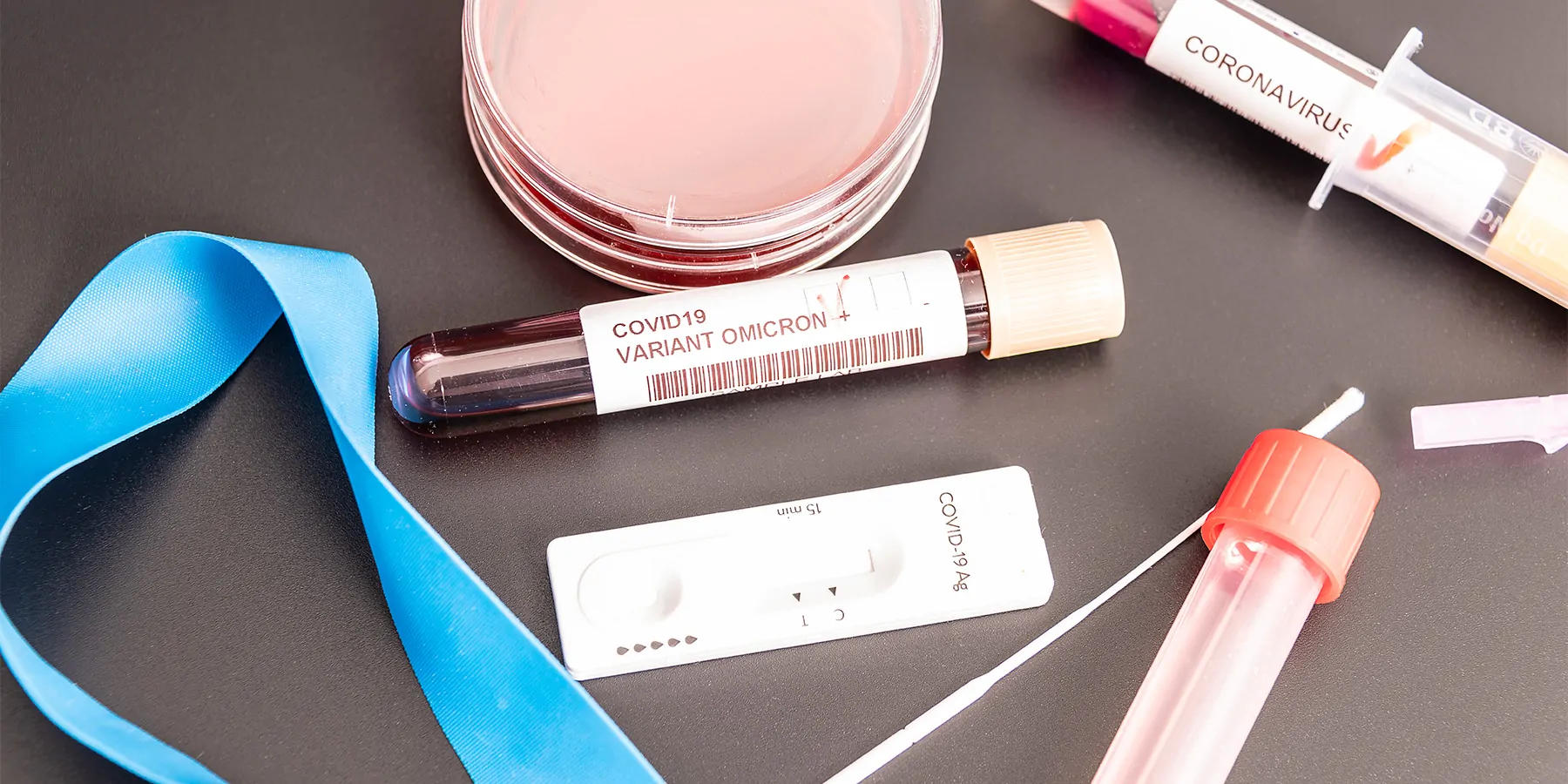 Moderna Announces Strategy to Address Omicron (B.1.1.529) SARS-CoV-2 Variant COVID-19 sampling and testing swabs and vials resting on a table