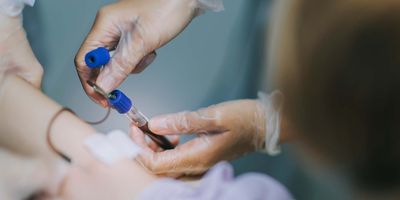 Health care professional drawing blood from a patient