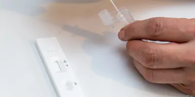 Person taking a rapid lateral flow COVID-19 test