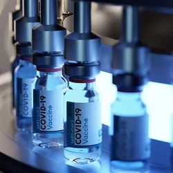 Vaccine bottles on a production line being filled