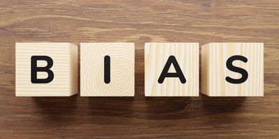Wooden blocks on a table that have letters on them that spell the word "Bias"