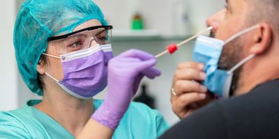 Professional administering a nasal swab for a COVID-19 test