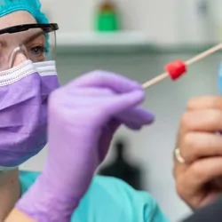 Professional administering a nasal swab for a COVID-19 test