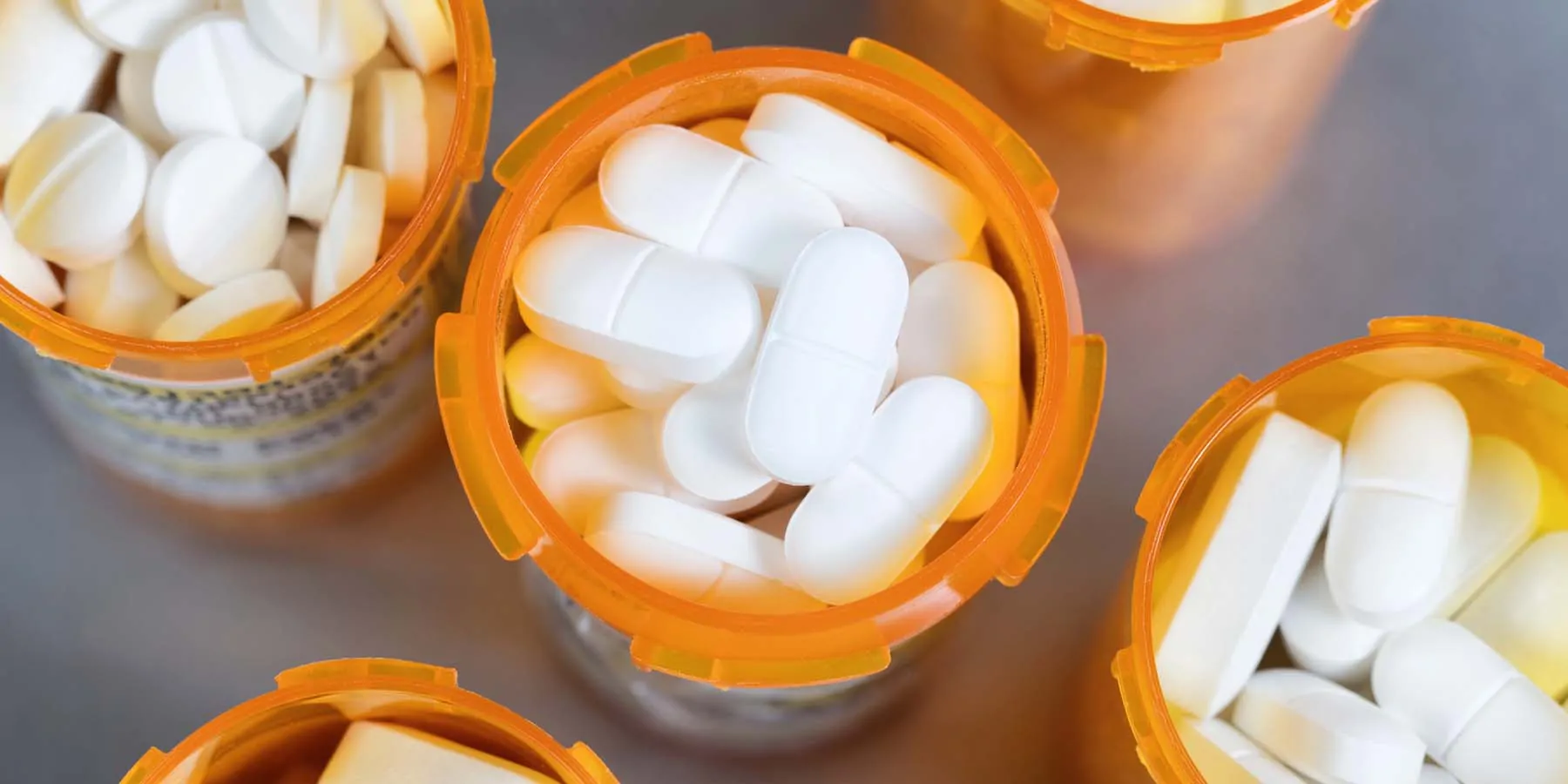 Open pill bottles filled with prescription drugs