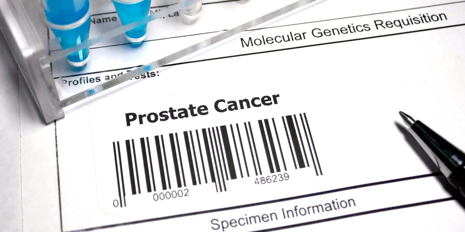 A form for a test with a barcode and the words prostate cancer on it next to liquid samples in tubes