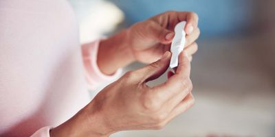 Women holding a pregnancy test