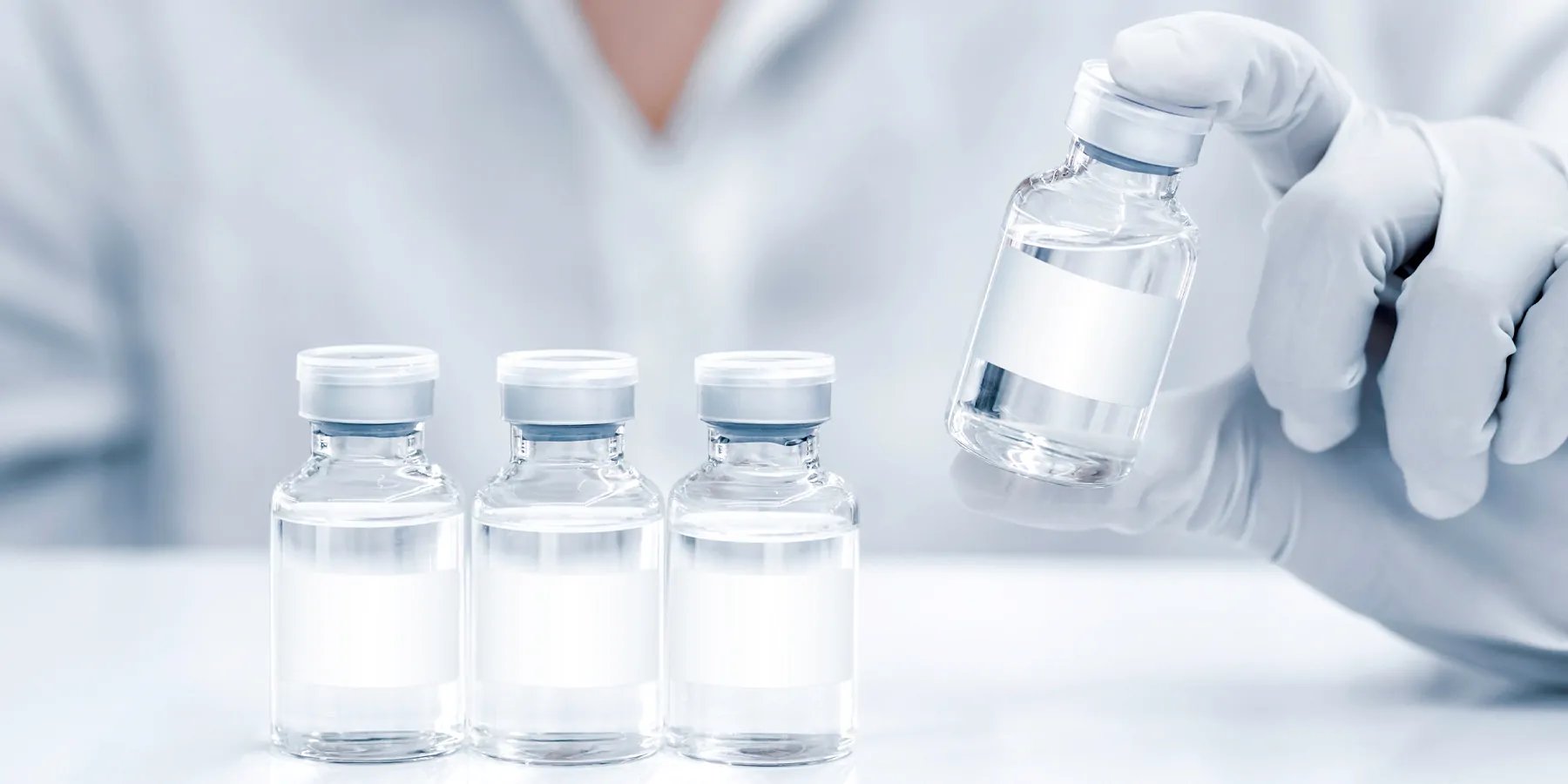 A clinical lab professionals wearing gloves holds a new class of universal vaccines 