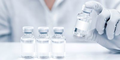 A clinical lab professionals wearing gloves holds a new class of universal vaccines 