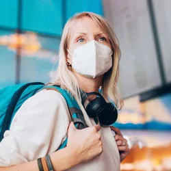 Women wearing mask traveling through an airport