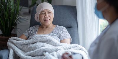 Cancer patient in a chair receiving therapy