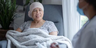 Cancer patient in a chair receiving therapy