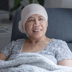 Cancer patient in a chair receiving therapy