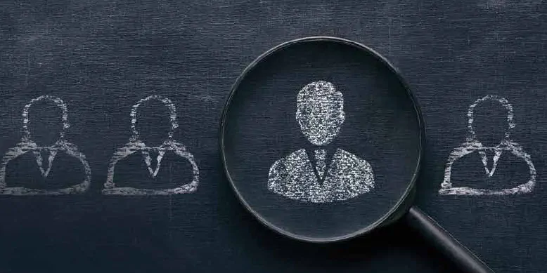 Illustration of a person silhouette drawn on a chalkboard in the middle of a magnifying glass.