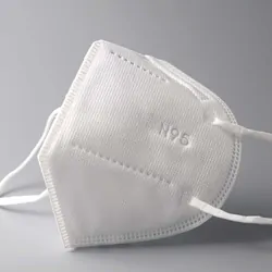 An N95 mask on a grey background