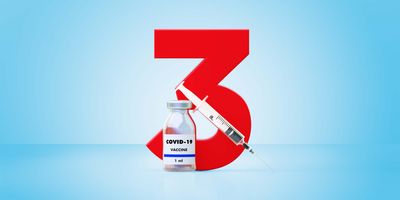 A number 3 behind a needle and a bottle of COVID-19 vaccine