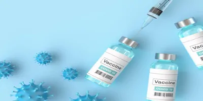 Needle drawing medicine from a bottled labled vaccine