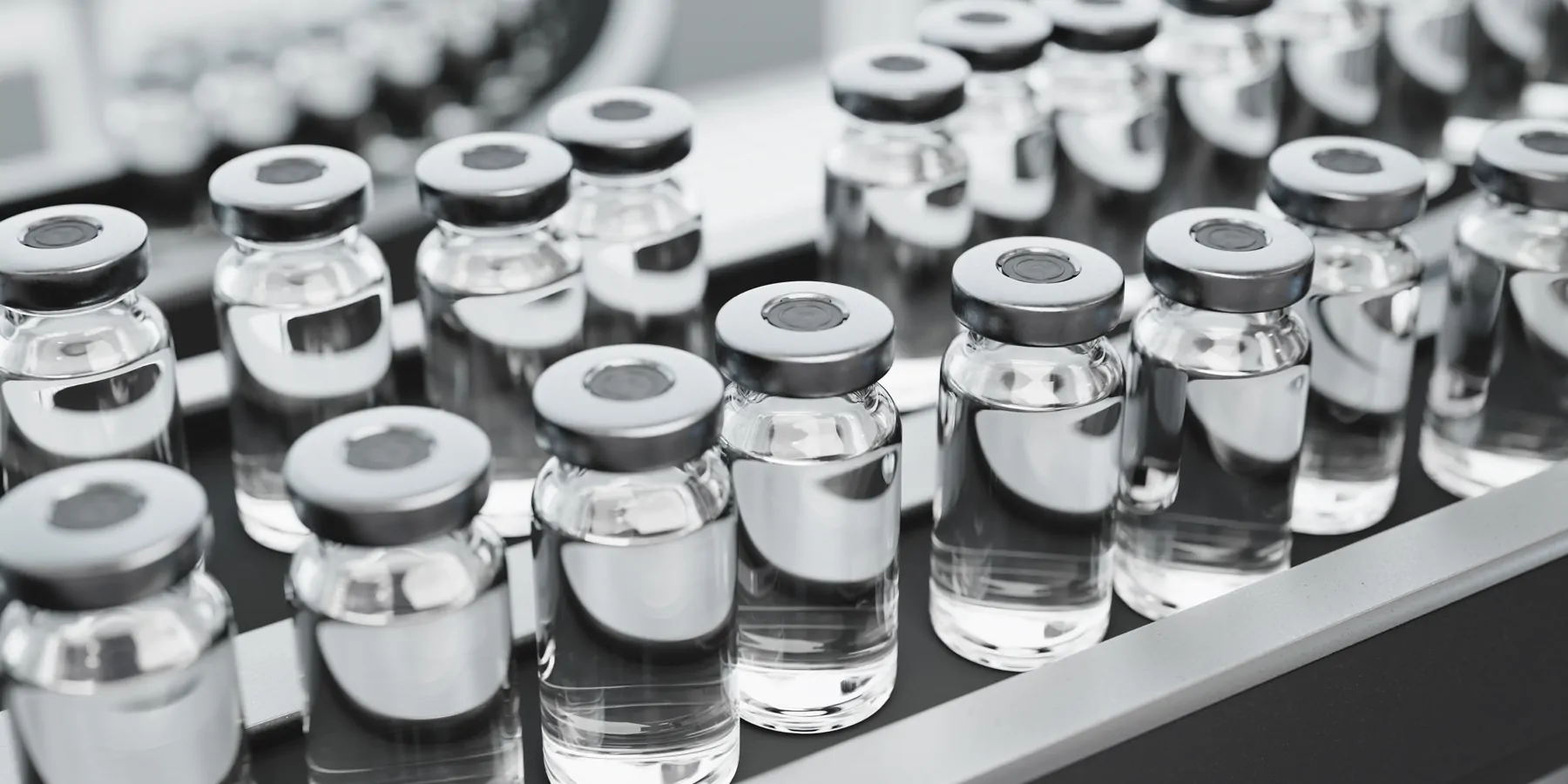 Liquid medication bottles on a conveyor
