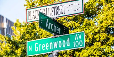 Black Wall Street and N Greenwood Avenue and Archer street signs, closeup, in Tulsa, Oklahoma.