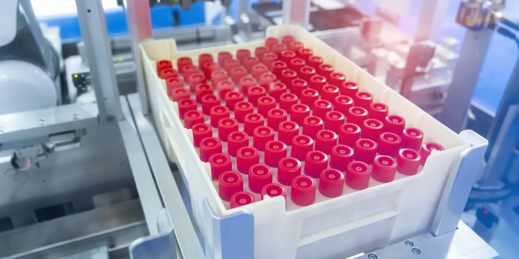 Robot arm in a clinical lab with test tubes for diagnostics assays.
