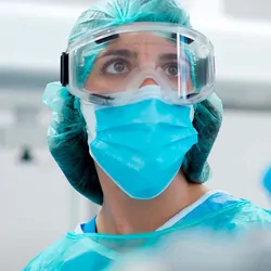 Health care provider in full PPE in a COVID-19 ward