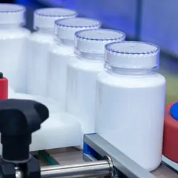 Photo of white plastic bottles of clinical laboratory reference materials for calibration verification.